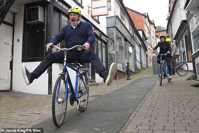 Lib Dem leader Ed Davey clowns around on a bicycle after his paddleboard stunt sparked ridicule yesterday