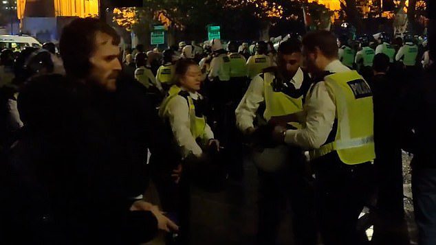 Violent Pro-Palestine mobs clash with police outside Downing Street as activists bang on car doors and block roads as Met Police officers forced to don riot gear and make arrests – on night that has seen chaos in France and Italy